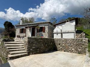 a stone house with a stone wall and stairs at Athanasia's Eremion in Zagora