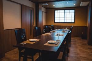 a large dining room with a long table with wine glasses at Kisara Bettei TOKI in Toba +85 photos