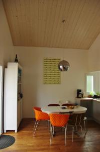 a kitchen with a table and chairs in a room at Chalet spacieux proche mer in Longeville-sur-Mer