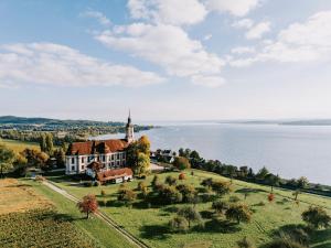 a church on a hill next to a body of water at Turmgarten in Überlingen