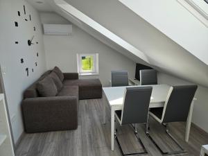 a living room with a table and a couch at Apartment Ledince in Most na Soči
