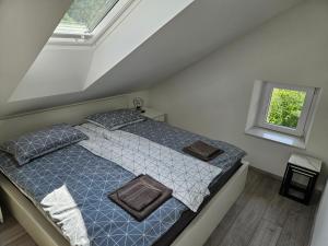 a bedroom with a bed with pillows and a window at Apartment Ledince in Most na Soči