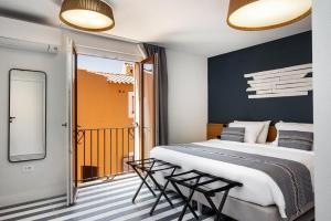 a bedroom with a large bed and a balcony at Valesmeralda Boutique Rooms, Porto Cervo Marina Adults only in Porto Cervo