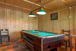 a pool table in a room with wooden walls at Zameczek in Mikołajki