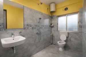 a bathroom with a sink and a toilet and a shower at Collection O Yellow Rose in kolkata +17 photos