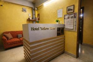 a hotel lobby with a hotel yellow kiss sign at Collection O Yellow Rose in kolkata