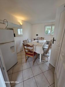 a kitchen and dining room with a table and chairs at PR2 - 2 Bedrooms and a Fully Equipped Kitchen in Le Blanc-Mesnil