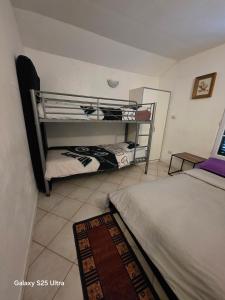 a bedroom with two beds and a bunk bed at PR2 - 2 Bedrooms and a Fully Equipped Kitchen in Le Blanc-Mesnil