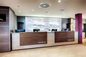 a lobby with a reception desk and a large screen at Premier Inn Koeln City Centre in Cologne