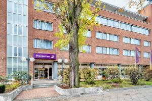a brick building with a tree in front of it at Premier Inn Koeln City Centre in Cologne