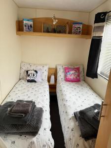 two twin beds in a small room at my happy place caravan in Trusthorpe