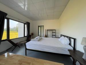 a bedroom with a bed and a large window at Katie's homestay in Ðông Mỹ (2) +291 photos