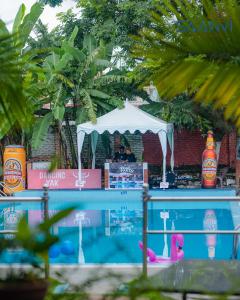 a man standing under a white tent next to a pool at Saanvi Hotel & Restaurant in Kathmandu +30 photos