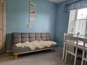 a living room with a couch and a table at Sweet-S in Boryspil
