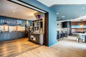 a restaurant with a bar with tables and chairs at Premier Inn Stuttgart Bad Cannstatt in Stuttgart