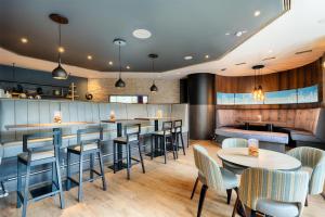 a restaurant with tables and chairs and a bar at Premier Inn Stuttgart Bad Cannstatt in Stuttgart +31 photos