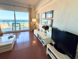 a living room with a large flat screen tv at Marenostrum view in Playa Pobla de Farnals