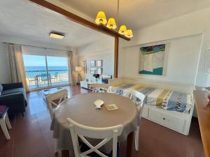 a room with a bed and a table and a couch at Marenostrum view in Playa Pobla de Farnals