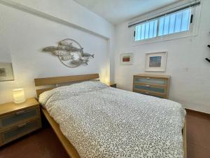 a bedroom with a bed and two dressers and a window at Marenostrum view in Playa Pobla de Farnals +14 photos