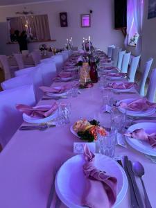 a long table with plates of food on it at Zameczek in Mikołajki