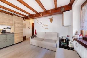 a living room with a couch and a kitchen at Casetta del Caregon a Vinigo in Vodo Cadore +16 photos