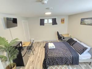 a bedroom with a bed and a desk and chairs at Cozy Newly Built Room in Halifax