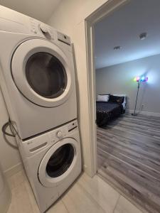 a washer and dryer in a room with a bedroom at Cozy Newly Built Room in Halifax +7 photos