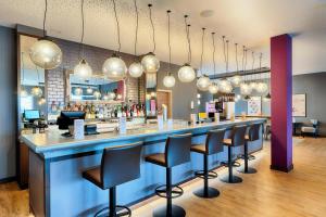 a bar with black stools in a restaurant at Premier Inn Lindau in Lindau