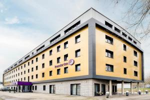 a large yellow and gray building on a street at Premier Inn Lindau in Lindau