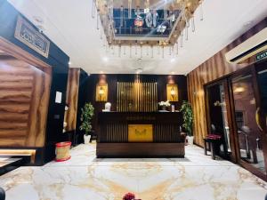 a lobby with a piano and a chandelier at HOTEL MADNI ROYALE (50 Mtrs from Dargaah), Ajmer in Ajmer