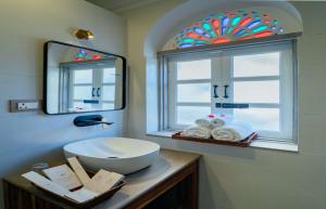 a bathroom with a sink and a mirror and a window at Sitaram Bhawan - A 250-Year- Old Heritage Haveli, Jaipur in Jaipur +37 photos