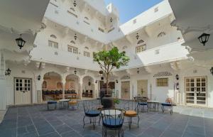 a courtyard of a building with tables and chairs at Sitaram Bhawan - A 250-Year- Old Heritage Haveli, Jaipur in Jaipur
