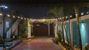 a garage with a string of lights and a driveway at Lucky garden inn in Chennai +7 photos