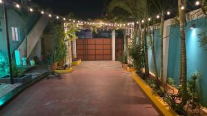 an entrance to a building with a gate and lights at Lucky garden inn in Chennai