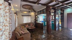 a living room with a couch and a table at Lucky garden inn in Chennai