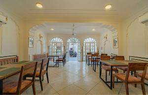 a dining room with tables and chairs in a building at Sitaram Bhawan - A 250-Year- Old Heritage Haveli, Jaipur in Jaipur