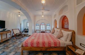 a bedroom with a bed and a couch in a room at Sitaram Bhawan - A 250-Year- Old Heritage Haveli, Jaipur in Jaipur