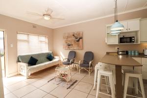 a kitchen and living room with a couch and a table at Sue Casa 3 in Margate