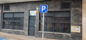 a blue parking sign in front of a building at Tanez Garden Apartamentos in Madrid