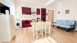 a kitchen with a table and chairs in a room at casa del sole in Taormina +24 photos