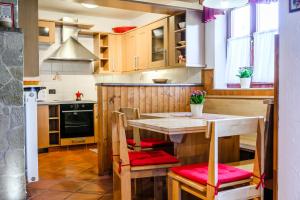 a kitchen with a wooden table and chairs at Albatros in Bovec +39 photos