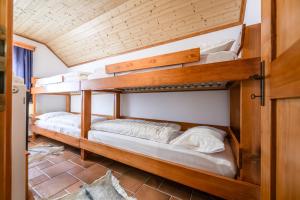 two bunk beds are in a room with a ceiling at Albatros in Bovec