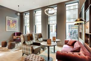 a living room with a couch and chairs and a table at Premier Inn Berlin Alexanderplatz in Berlin