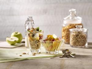 a table with a bowl of fruit and a jar of nuts at Premier Inn Berlin Alexanderplatz in Berlin +26 photos