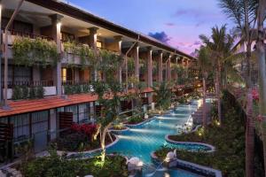 an image of a hotel courtyard with a swimming pool at Bali Dynasty Resort in Kuta