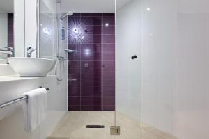 a bathroom with a glass shower and a sink at Premier Inn Stuttgart Feuerbach in Stuttgart +16 photos