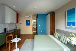 a living room with a couch and a kitchen at Well-being Home - Self-Service in Hanoi