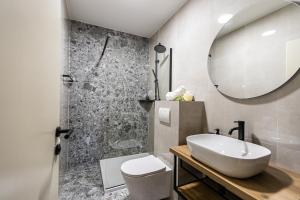 a bathroom with a sink and a toilet and a mirror at Hotel Klek in Ogulin +23 photos