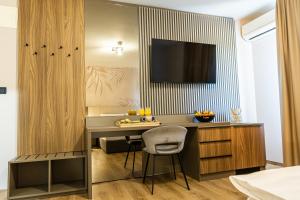 a kitchen with a desk and a chair in a room at Hotel Klek in Ogulin