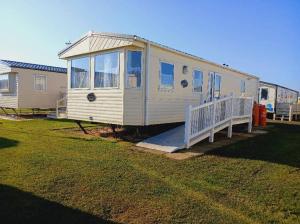 a tiny house is parked in a yard at 6Berth Caravan-Wheelchair Accessible-Pet Friendly in Skegness